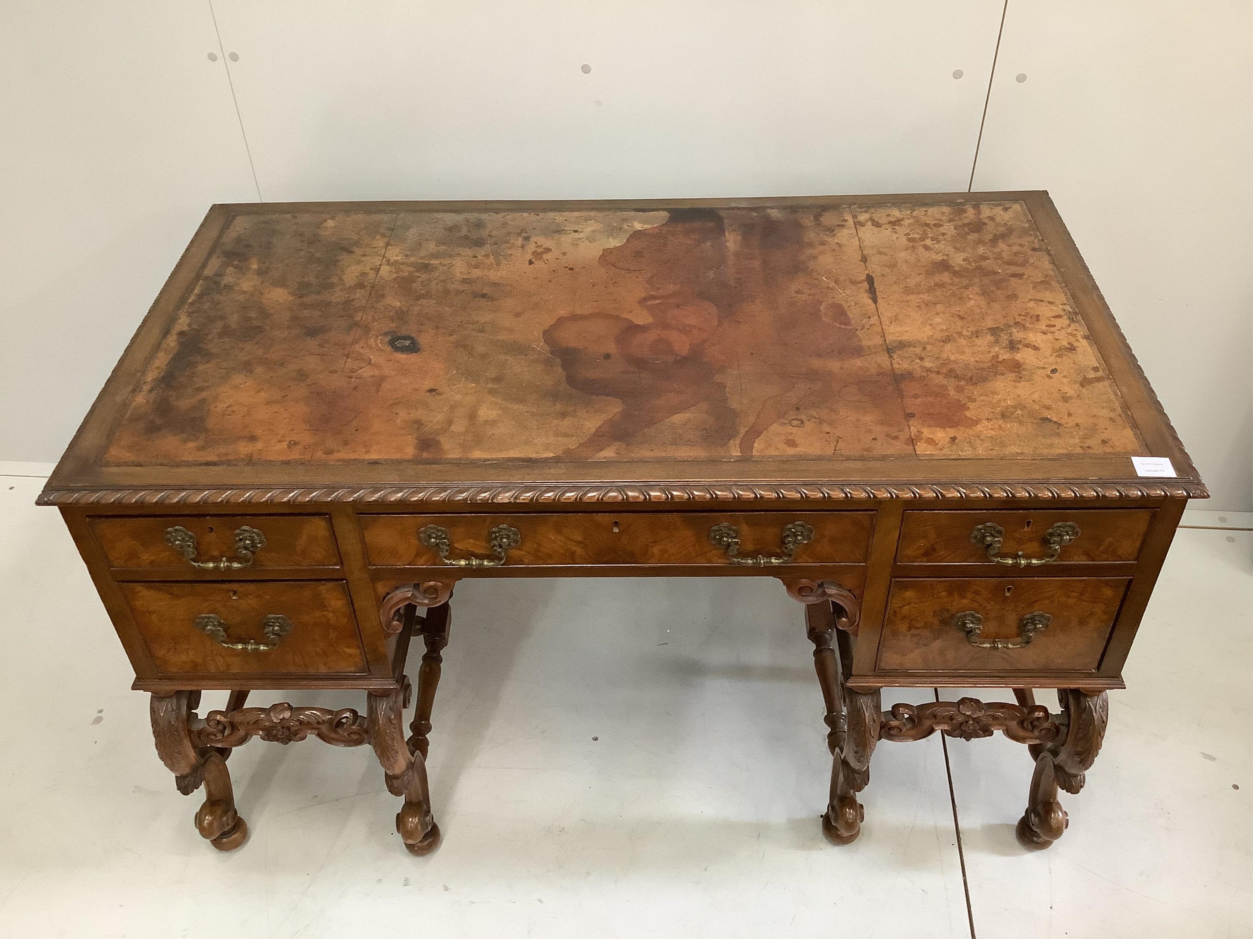 A Queen Anne Revival mahogany kneehole desk, width 129cm, depth 68cm, height 77cm. Condition - fair